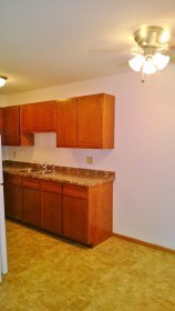 a kitchen with wooden cabinets and a counter top